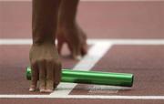 31 August 2003; A relay athlete holds the baton on the starting block in the Men's 4 X 100m Final during the ninth day's competition at the 9th IAAF World Championships in Athletics at the Stade de France, Paris, France. Picture credit; Brendan Moran / SPORTSFILE