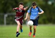 19 August 2018; Gus Lohan of Oranmore, Co. Galway in action against Liam Keane of Ballynacally-Lissycasey, Co. Clare competing in the Gaelic Football U10 Final event during day two of the Aldi Community Games August Festival at the University of Limerick in Limerick. Photo by Harry Murphy/Sportsfile