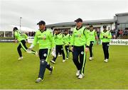 20 August 2018; Ireland captain Gary Wilson, left, leads his side out prior to the T20 International cricket match between Ireland and Afghanistan at Bready Cricket Club, in Magheramason, Co. Tyrone. Photo by Seb Daly/Sportsfile