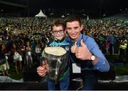 20 August 2018; Muris McCarthy, age 7, from Dromcollogher, County Limerick and Gearóid Hegarty celebrate with the Liam MacCarthy Cup during the Limerick All-Ireland Hurling Winning team homecoming at the Gaelic Grounds in Limerick. Photo by Diarmuid Greene/Sportsfile