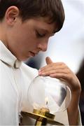 26 August 2018; A member of the communion procession maintains a flame during the closing mass of Pope Francis visit to Ireland at the Phoenix Park in Dublin. Photo by Stephen McCarthy/Sportsfile