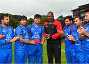 27 August 2018; Hazratullah Zazai of Afghanistan, centre, is presented with a cap by captain Asghar Afghan, left, and head coach Phil Simmons, right, prior to the One Day International match between Ireland and Afghanistan at Stormont Cricket Ground, Belfast, Co. Antrim. Photo by Seb Daly/Sportsfile