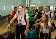 27 August 2018; Orla Comerford of Ireland with her Bronze medals from the Women's T13 100m and 200m events, followed by teammates Niamh McCarthy and Noelle Lenihan, as Team Ireland return from the 2018 World Para Athletics European Championships at Dublin Airport in Dublin. Photo by Sam Barnes/Sportsfile