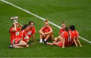 9 September 2018; Cork players, from left, Hannah Looney, Orla Cotter, Chloe Sigerson, Laura Treacy, Libby Coppinger, Orla Cronin and Gemma O'Connor relax with the O'Duffy Cup after the Liberty Insurance All-Ireland Senior Camogie Championship Final match between Cork and Kilkenny at Croke Park in Dublin. Photo by Piaras Ó Mídheach/Sportsfile