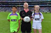 16 September 2018; Referee Garryowen McMahon with match ball ppresenters Temi Falegan and Réiltín Candan, both from St Laurence O’Toole NS, Seville Place, Dublin, prior to the TG4 All-Ireland Ladies Football Senior Championship Final match between Cork and Dublin at Croke Park, Dublin. Photo by Brendan Moran/Sportsfile