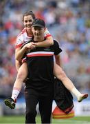 16 September 2018; Tyrone Assistant manager Barry Grimes gives Áine Canavan a lift across the pitch after the TG4 All-Ireland Ladies Football Intermediate Championship Final match between Meath and Tyrone at Croke Park, Dublin. Photo by Piaras Ó Mídheach/Sportsfile