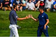 28 September 2018; Dustin Johnson of USA, left, and Rory McIlroy of Europe shake hands on the 16th green following their Fourball Match during the Ryder Cup 2018 Matches at Le Golf National in Paris, France. Photo by Ramsey Cardy/Sportsfile