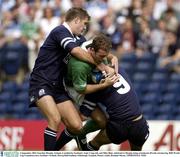 6 September 2003; Geordan Murphy, Ireland, is tackled by Scotland's Andy Craig, left, and Mike Blair, which led to Murphy being stretchered off with a broken leg. RBS World Cup Countdown test, Scotland v Ireland, Murrayfield Stadium, Edinburgh, Scotland. Picture credit; Brendan Moran / SPORTSFILE *EDI*