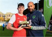 14 October 2018; Cian Kavanagh of St. Patrick's Athletic receives the man of the match trophy from Republic of Ireland Under-16 head coach Paul Osam following the National Under 15 Cup Final match between St. Patrick's Athletic and Cork City at Richmond Park in Inchicore, Dublin. Photo by Tom Beary/Sportsfile