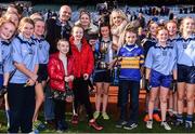 22 October 2018; Grace Murphy-Cruse of Scoil Mhuire, Sandymount, Co. Dublin, and her teammates are presented with the cup by the family of former press photographer Austin Finn, from left, from left, his son Conor, and daughters Orla and Yvonne during day 1 of the Allianz Cumann na mBunscol Finals at Croke Park in Dublin.  Photo by Sam Barnes/Sportsfile