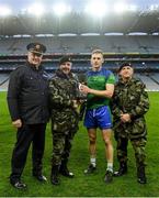 22 October 2018; The winning captain Denis Maher of The Irish Defence Forces is presented with the cup by, from left, Assistant Commissioner of An Garda Síochána Fintan Fanning alongside Chief of Staff Mark Mellet and Major General Kieran Brennan, of The Irish Defence Forces, after the President's Cup match between The Irish Defence Forces and An Garda Síochána at Croke Park in Dublin. Photo by Piaras Ó Mídheach/Sportsfile