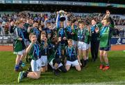 23 October 2018; Kyle Ó'Leathlobhair from Gaelscoil Eiscir Riada, Leamhcán, Co. Dublin lifts the trophy with his teammates during day 2 of the Allianz Cumann na mBunscol Finals at Croke Park in Dublin. Photo by Harry Murphy/Sportsfile