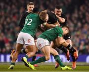 17 November 2018; Jack Goodhue of New Zealand is tackled by Bundee Aki, left, and Garry Ringrose of Ireland during the Guinness Series International match between Ireland and New Zealand at the Aviva Stadium in Dublin. Photo by Brendan Moran/Sportsfile