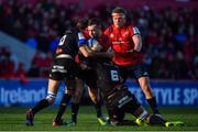 9 December 2018; JJ Hanrahan of Munster is tackled by Yannick Caballero and Mathieu Babillot of Castres Olympique during the European Rugby Champions Cup Pool 2 Round 3 match between Munster and Castres at Thomond Park in Limerick. Photo by Brendan Moran/Sportsfile