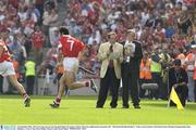 14 September 2003; The Cork team run out onto the pitch before the game as Marty Morrissey (light jacket) announces the &quot;All-Ireland Hurling Brothers&quot; to the crowd. Guinness All-Ireland Senior Hurling Championship Final, Kilkenny v Cork, Croke Park, Dublin. Picture credit; David Maher / SPORTSFILE *EDI*