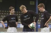 19 September 2003; Leinster and Ireland centre Brian O'Driscoll launched the inaugural Powerade Rugby Skills Challenge at Donnybrook. The initiative will run in Leinster schools and is aimed at rugby players in 1st and 2nd year. Brian shows some passing skills to Kevin McEvoy, left, and Ciaran O'Grady, from Blackrock College, at the launch. Picture credit; Brendan Moran / SPORTSFILE *EDI*