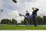 19 September 2003; Leinster and Ireland centre Brian O'Driscoll launched the inaugural Powerade Rugby Skills Challenge at Donnybrook. The initiative will run in Leinster schools and is aimed at rugby players in 1st and 2nd year. Brian shows some kicking skills to Diarmuid Meldon, from Blackrock College, at the launch. Picture credit; Brendan Moran / SPORTSFILE *EDI*