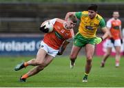 13 January 2019; Rian O'Neill of Armagh in action against Brendan McCole of Donegal during the Bank of Ireland Dr McKenna Cup semi-final match between Donegal and Armagh at Healy Park in Tyrone. Photo by Oliver McVeigh/Sportsfile