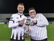 25 January 2019; Dundalk's Dane Massey is presented with the trophy by supporter Cillian Moran following his victory during the Jim Malone Cup match between Dundalk and Drogheda United at Oriel Park in Dundalk, Co. Louth. Photo by Seb Daly/Sportsfile