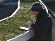 2 February 2019; A racegoer studies the form prior to racing on Day One of the Dublin Racing Festival at Leopardstown Racecourse in Dublin. Photo by Seb Daly/Sportsfile