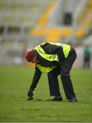 3 February 2019; A steward attempts to repair divots at half time during the Allianz Football League Division 2 Round 2 match between Cork and Kildare at Páirc Uí Chaoimh in Cork. Photo by Eóin Noonan/Sportsfile