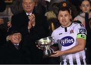9 February 2019; Dundalk captain Brian Gartland after being presented with the President's Cup by President of Ireland Michael D Higgins following the 2019 President's Cup Final between Cork City and Dundalk at Turners Cross in Cork. Photo by Stephen McCarthy/Sportsfile