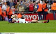 28 September 2003; Tyrone captain Peter Canavan lies on the pitch hearing the final whistle after victory over Armagh. Bank of Ireland All-Ireland Senior Football Championship Final, Armagh v Tyrone, Croke Park, Dublin. Picture credit; David Maher / SPORTSFILE *EDI*