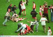 28 September 2003; Tyrone players and fans celebrate at the final whistle after victory over Armagh. Bank of Ireland All-Ireland Senior Football Championship Final, Armagh v Tyrone, Croke Park, Dublin. Picture credit; Ray McManus / SPORTSFILE