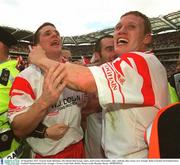 28 September 2003; Tyrone's Enda McGinley, left, Declan McCrossan, centre, and Cormac McAnallen, right, celebrate after victory over Armagh. Bank of Ireland All-Ireland Senior Football Championship Final, Armagh v Tyrone, Croke Park, Dublin. Picture credit; Brendan Moran / SPORTSFILE