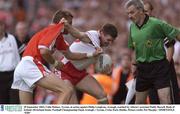 28 September 2003; Colin Holmes, Tyrone, in action against Philip Loughran, Armagh, watched by referee's assistant Paddy Russell. Bank of Ireland All-Ireland Senior Football Championship Final, Armagh v Tyrone, Croke Park, Dublin. Picture credit; Pat Murphy / SPORTSFILE *EDI*