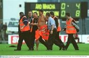 28 September 2003; A pitch invader is removed from the pitch during the Bank of Ireland All-Ireland Senior Football Championship Final, Armagh v Tyrone, Croke Park, Dublin. Picture credit; Brendan Moran / SPORTSFILE