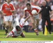 28 September 2003; Ronan Clarke, Armagh, in action against Tyrone's Brian Dooher. Bank of Ireland All-Ireland Senior Football Championship Final, Armagh v Tyrone, Croke Park, Dublin. Picture credit; Pat Murphy / SPORTSFILE *EDI*