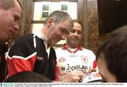29 September 2003; Tyrone manager Mickey Harte signs autographs for fans prior to their departure from the hotel for their home coming in Tyrone. Burlington Hotel, Dublin. Picture credit; Pat Murphy / SPORTSFILE *EDI*