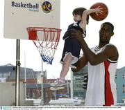9 October 2003; 3 year old Laura Roantree slam dunks with the help of Notre Dame's Bruce Jolly at the launch of the ESB Super League season and of Basketball Ireland. Clarion Hotel, Dublin. Picture credit; Ray McManus / SPORTSFILE *EDI*