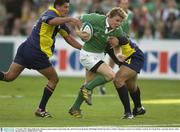 11 October 2003; Brian O'Driscoll, Ireland, in action against Lucian Sirbu, left, and Sorin Socol, Romania. 2003 Rugby World Cup, Pool A, Ireland v Romania, Central Coast Stadium, Gosford, New South Wales, Australia. Picture credit; Brendan Moran / SPORTSFILE *EDI*