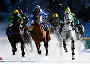 17 February 2019; Heloagain with Silvia Casanova, blue silks, up lead the field on their way to winning the GP Guardaval Immobilien-Zuoz und Blasto race at the White Turf horse racing event at St Moritz, Switzerland. Photo by Ramsey Cardy/Sportsfile