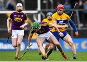 24 February 2019; (EDITORS NOTE; This image contains graphic content) John Conlon of Clare goes over on his left ankle while trying to tackle Darren Byrne of Wexford during the Allianz Hurling League Division 1A Round 4 match between Clare and Wexford at Cusack Park in Ennis, Clare. Photo by Eóin Noonan/Sportsfile