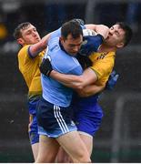 3 March 2019; Dean Rock of Dublin is tackled by Conor Devaney, left, and Conor Daly of Roscommon during the Allianz Football League Division 1 Round 5 match between Roscommon and Dublin at Dr Hyde Park in Roscommon. Photo by Ramsey Cardy/Sportsfile