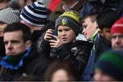 3 March 2019; A young Leitrim fan checks his phone during the Allianz Football League Division 4 Round 5 match between Leitrim and London at Avantcard Páirc Seán Mac Diarmada in Carrick-on-Shannon, Co. Leitrim. Photo by Oliver McVeigh/Sportsfile
