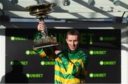 12 March 2019; Mark Walsh celebrates with the trophy after winning the Unibet Champion Hurdle Challenge Trophy on Day One of the Cheltenham Racing Festival at Prestbury Park in Cheltenham, England. Photo by David Fitzgerald/Sportsfile