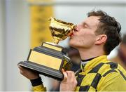 15 March 2019; Jockey Paul Townend celebrates with the trophy after winning the Magners Cheltenham Gold Cup Chase on Al Boum Photo on Day Four of the Cheltenham Racing Festival at Prestbury Park in Cheltenham, England. Photo by Seb Daly/Sportsfile