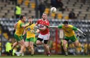 16 March 2019; Ruairi Deane of Cork in action against Leo McLoone, left, and Ryan McHugh of Donegal during the Allianz Football League Division 2 Round 6 match between Cork and Donegal at Páirc Uí Rinn in Cork. Photo by Eóin Noonan/Sportsfile