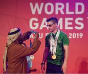 17 March 2019; Team Ireland's Patrick Quinlivan, a member of the Salto SOC from Letterkenny, Co. Donegal, receives the third of his seven medals for Artistic Gymnastics from H.H. Abdulla Bin Mohomed Al Hamed on Day Three of the 2019 Special Olympics World Games in the Abu Dhabi National Exhibition Centre, Abu Dhabi, United Arab Emirates. Photo by Ray McManus/Sportsfile