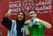 17 March 2019; Team Ireland's Patrick Quinlivan, a member of the Salto SOC from Letterkenny, Co. Donegal, who won seven medals, two Gold and five Silver, for Artistic Gymnastics poses with a local volunteer for a 'selfie' on Day Three of the 2019 Special Olympics World Games in the Abu Dhabi National Exhibition Centre, Abu Dhabi, United Arab Emirates. Photo by Ray McManus/Sportsfile