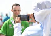 20 March 2019; Team Ireland's Andrew Simington, a member of Blackrock Flyers Special Olympics Club, from Dalkey, Co. Dublin, is photographed by Media Operations Volunteer Sultan Albloushi after he had collected the Gold Medal in the Level 2 - Unified Alternate Shot Team Play Competition on Day Six of the 2019 Special Olympics World Games in Yas Links, Yas Island, Abu Dhabi, United Arab Emirates  Photo by Ray McManus/Sportsfile