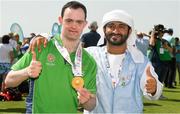 20 March 2019; Team Ireland's Andrew Simington, a member of Blackrock Flyers Special Olympics Club, from Dalkey, Co. Dublin, is photographed with Media Operations Volunteer Sultan Albloushi after he had collected the Gold Medal in the Level 2 - Unified Alternate Shot Team Play Competition on Day Six of the 2019 Special Olympics World Games in Yas Links, Yas Island, Abu Dhabi, United Arab Emirates  Photo by Ray McManus/Sportsfile