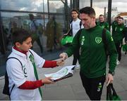 21 March 2019; Republic of Ireland assistant coach Robbie Keane signs an autograph on the squad's arrival at Gibraltar International Airport ahead of the UEFA EURO2020 Qualifier between Republic of Ireland and Gibraltar. Photo by Stephen McCarthy/Sportsfile