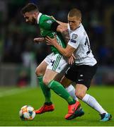21 March 2019; Stuart Dallas of Northern Ireland in action against Henrik Ojamaa of Estonia during the UEFA EURO2020 Qualifier - Group C match between Northern Ireland and Estonia at National Football Stadium in Windsor Park, Belfast.  Photo by David Fitzgerald/Sportsfile