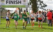 23 March 2019;  Emma Landers of Pobalscoil Ns Trionoide, Co.Cork, Ireland, passes over to Fiontann Campbell of St Malachys College, Co.Antrim, Ireland, whilst competing in the mixed relay event during the SIAB Schools Cross Country International at Santry Demense in Santry, Dublin. Photo by Sam Barnes/Sportsfile