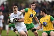 24 March 2019; Peter Kelly of Kildare in action against Jason McGee of Donegal  during the Allianz Football League Division 2 Round 7 match between Donegal and Kildare at Fr. Tierney Park in Ballyshannon, Donegal. Photo by Oliver McVeigh/Sportsfile